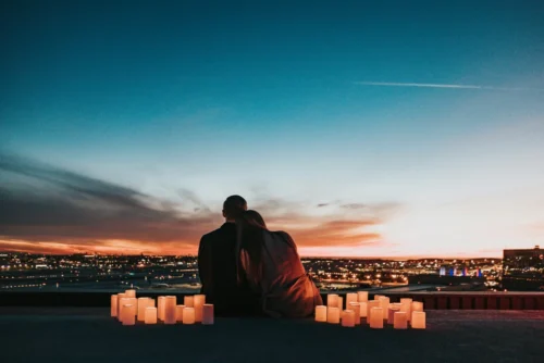 A couple spending a romantic time at sunset with candles