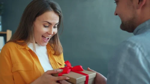 Person giving their loved one a present