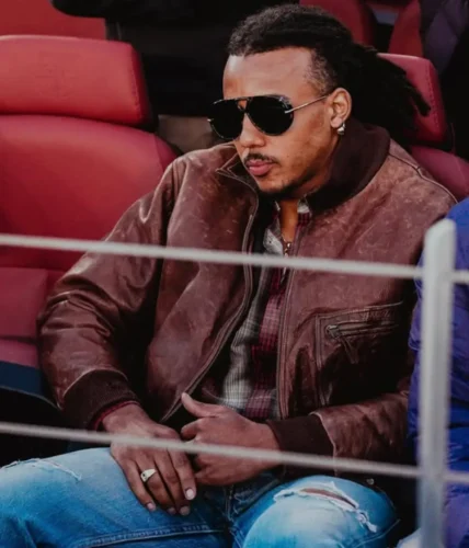 Jules Kundé in a streetwear outfit watching a Barcelona game